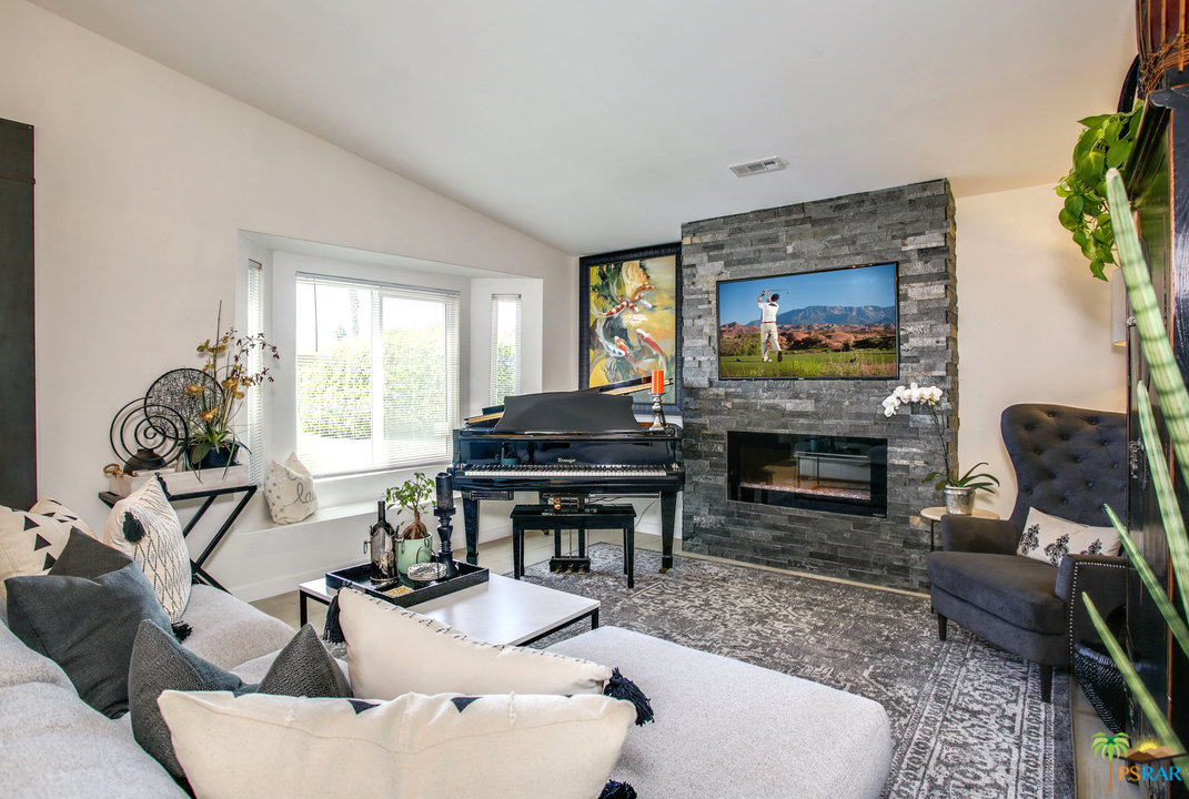 68120 Risueno Road Cathedral City, CA 92234 - Photo 6 of 35 a living room with furniture a flat screen tv and a fireplace