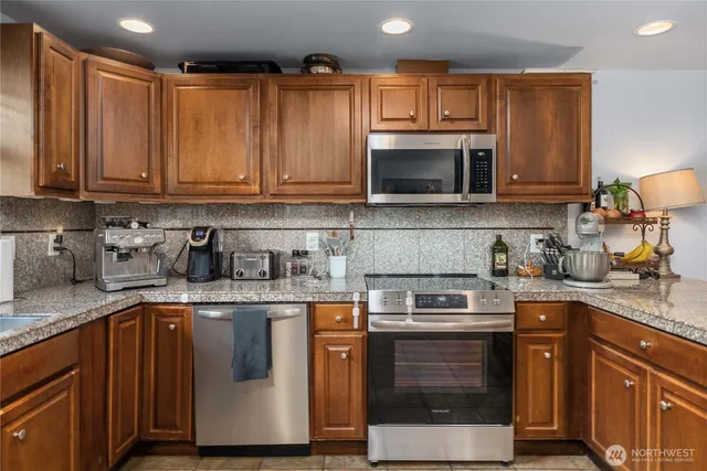 a kitchen with a sink stove and microwave
