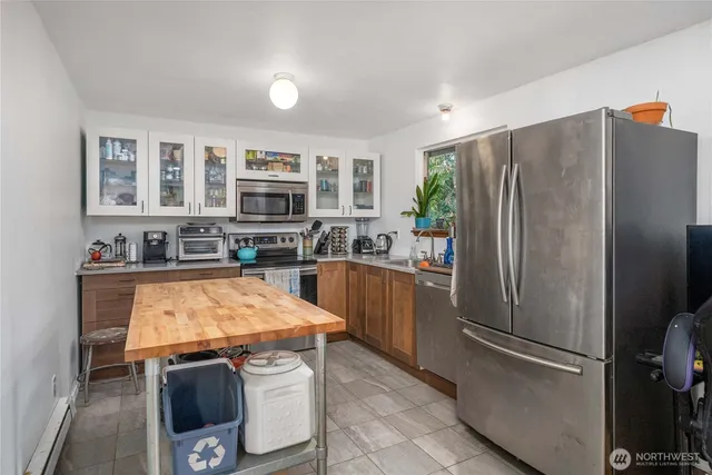 a kitchen with stainless steel appliances granite countertop a refrigerator stove and oven