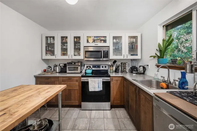 a kitchen with stainless steel appliances granite countertop a stove and a sink