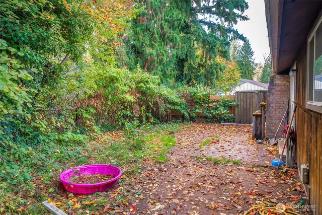 a backyard of a house with table and chairs