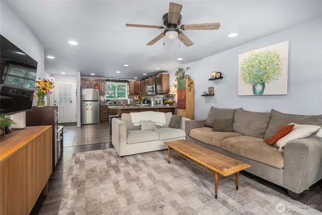 a living room with furniture and a chandelier