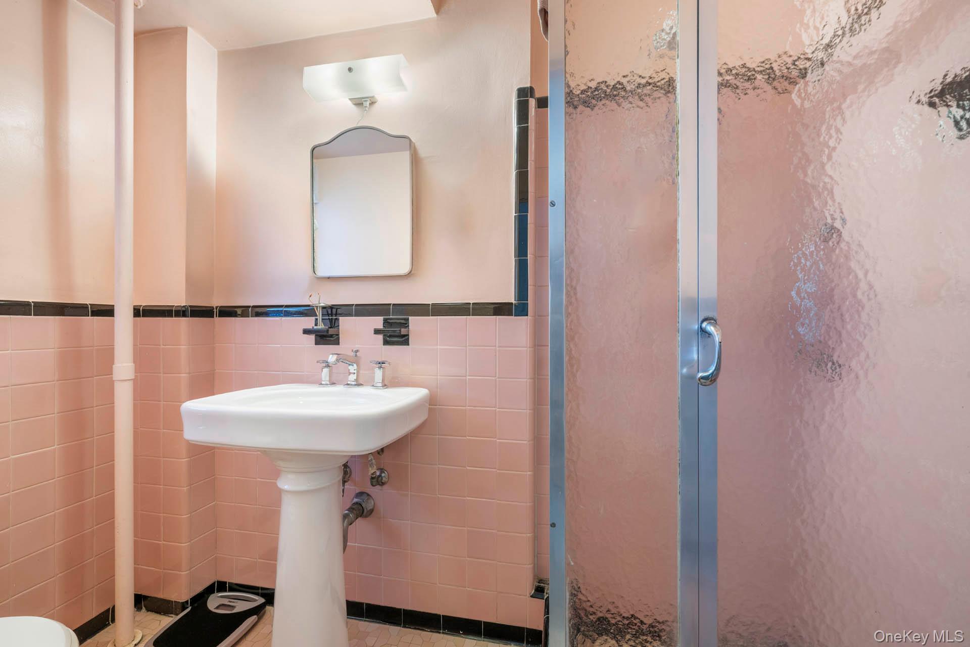 3135 Johnson Avenue, Unit 16C Bronx, NY 10463 - Photo 8 of 13 Bathroom featuring tile walls, a shower stall, and wainscoting