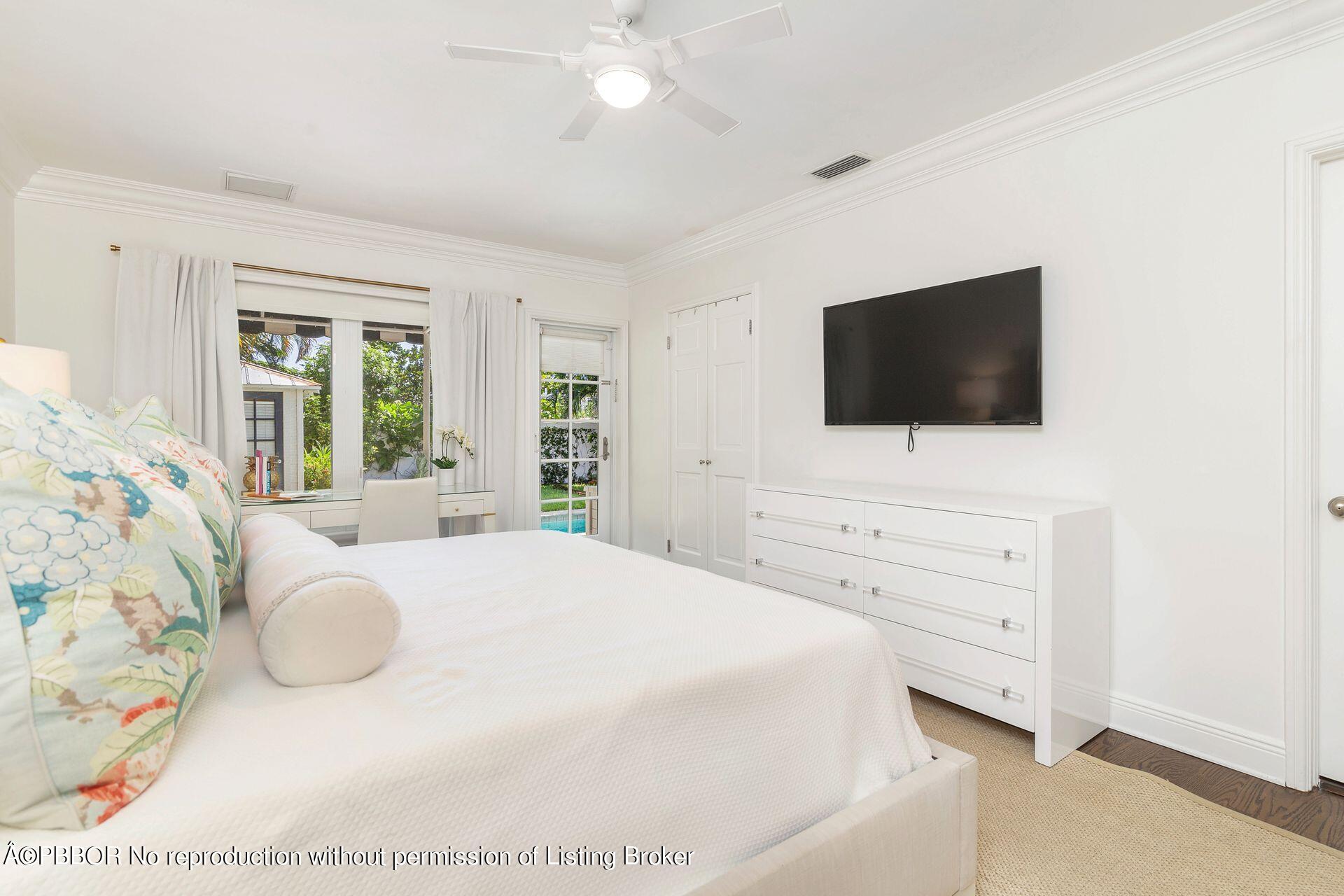 231 Cocoanut Row Palm Beach, FL 33480 - Photo 13 of 27 a bedroom with a bed and a flat screen tv