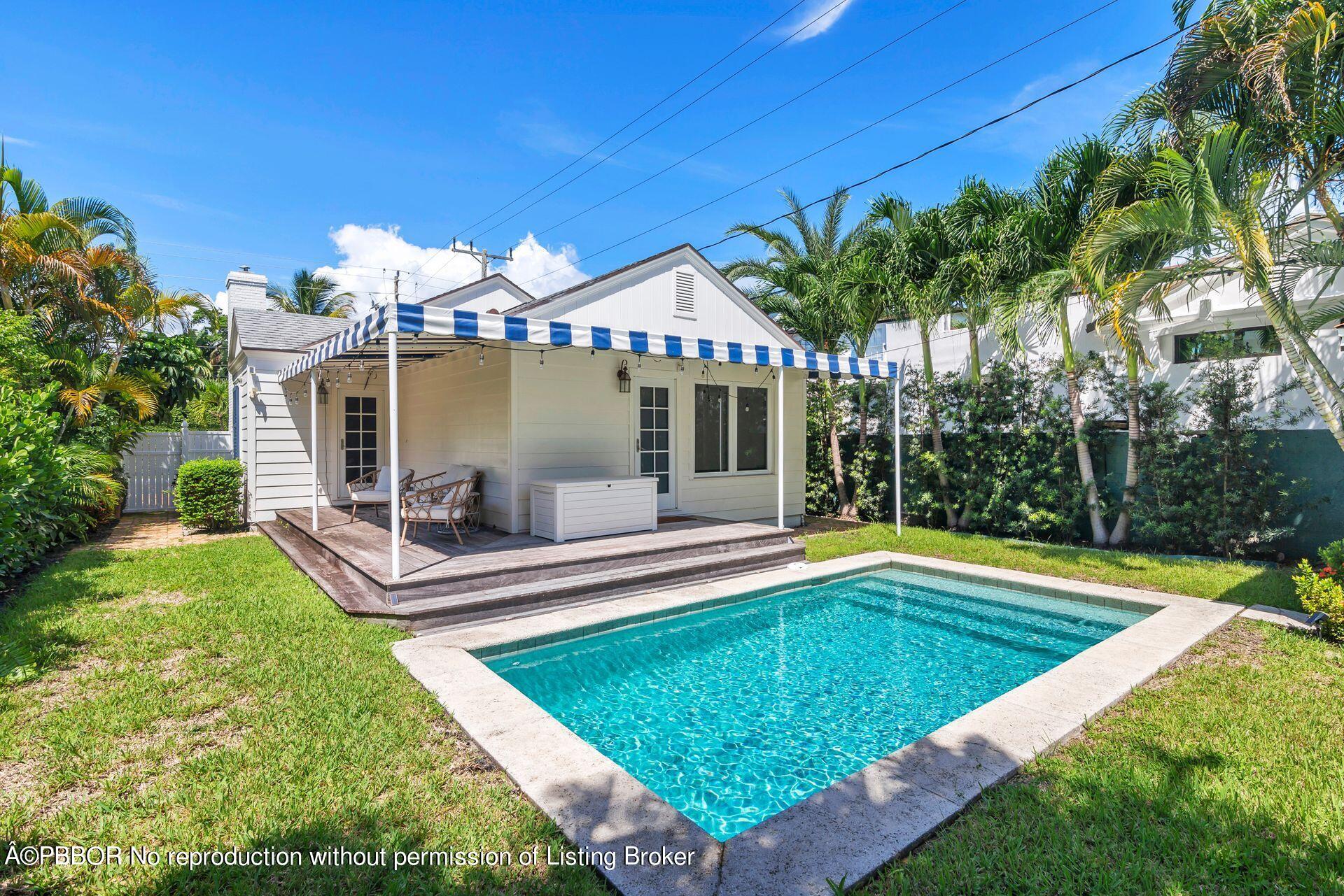 231 Cocoanut Row Palm Beach, FL 33480 - Photo 19 of 27 a view of a house with a swimming pool and sitting area