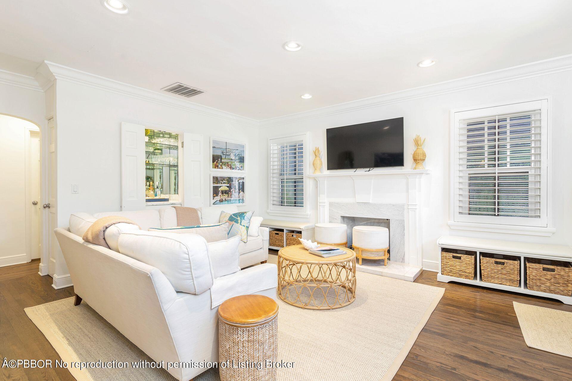 231 Cocoanut Row Palm Beach, FL 33480 - Photo 6 of 27 a living room with furniture a fireplace and a flat screen tv