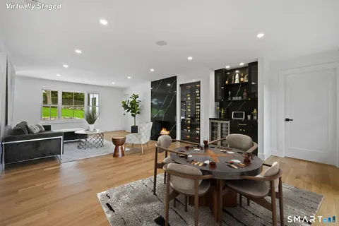a living room with furniture a rug and a large window