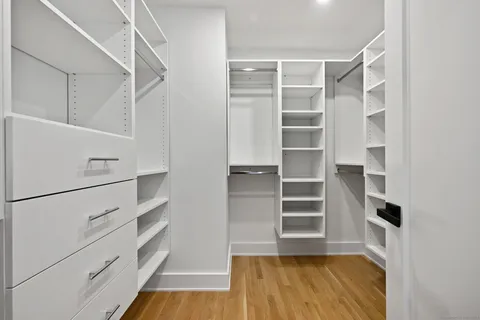 a view of walk in closet with empty racks