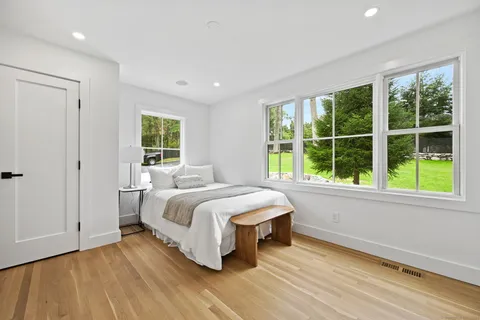 a bed room with two bed and a window