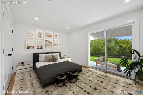 a bedroom with furniture and a large window