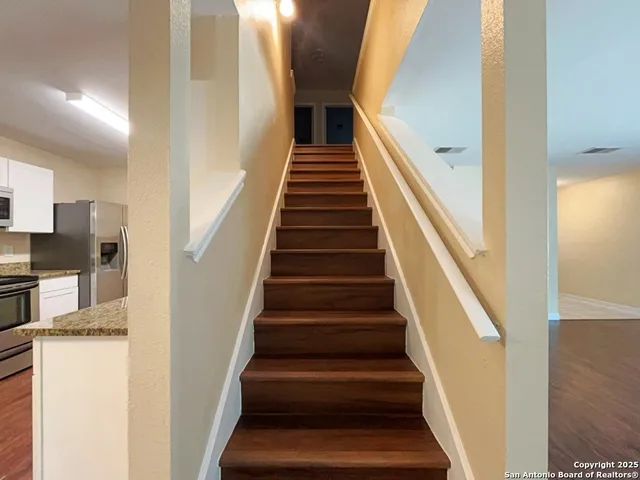 a view of entryway and hall with wooden floor