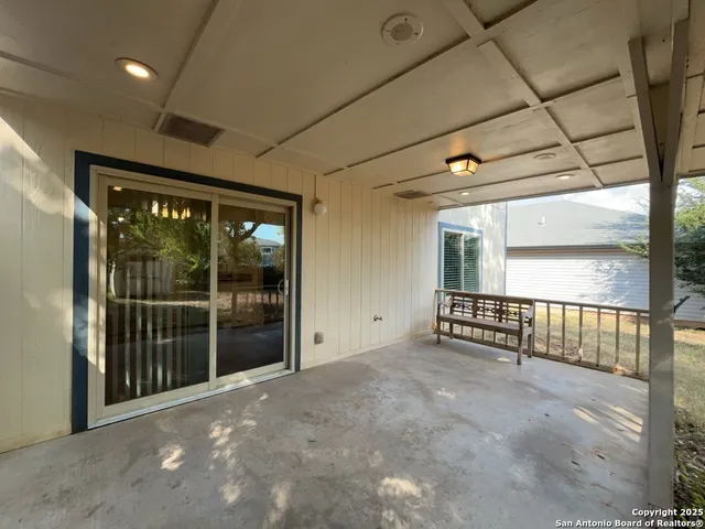 a view of an empty room with sliding glass door