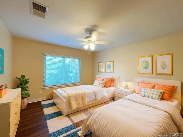 a bedroom with two beds and a chandelier