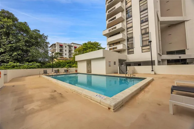 a view of swimming pool with a lounge chairs