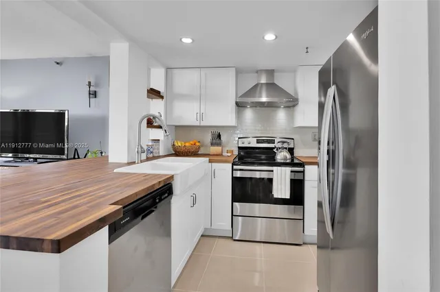 a kitchen with a appliances and cabinets