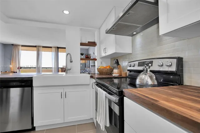 a kitchen with kitchen island a stove a sink and a refrigerator