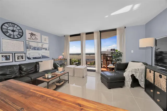 a living room with furniture a rug and a window