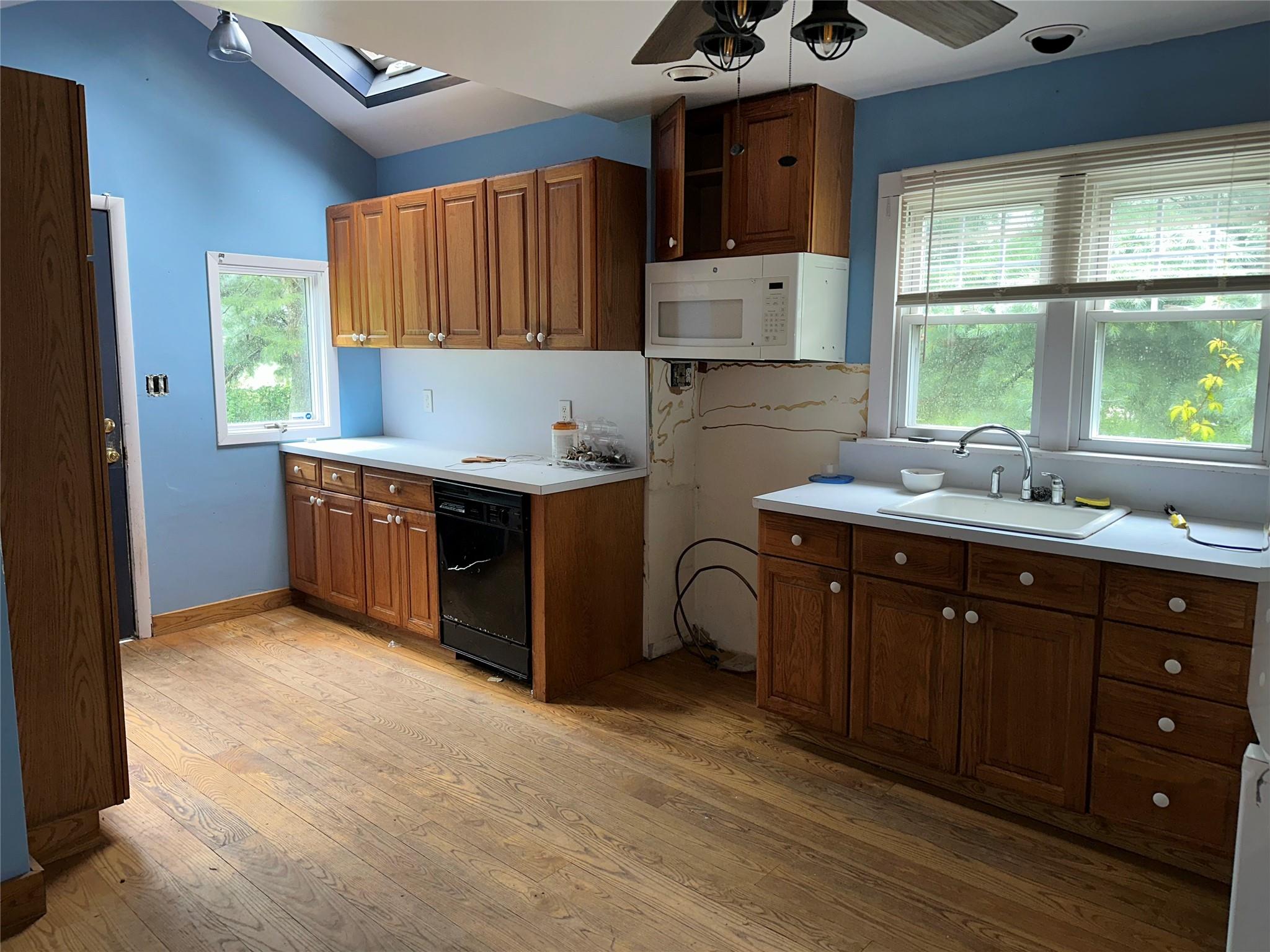 77 Lincoln Road Medford, NY 11763 - Photo 5 of 14 a kitchen with a sink window and cabinets