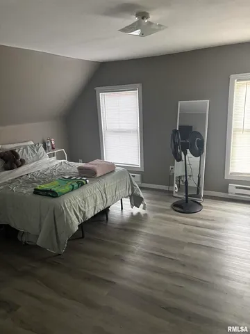 a bedroom with bed and window