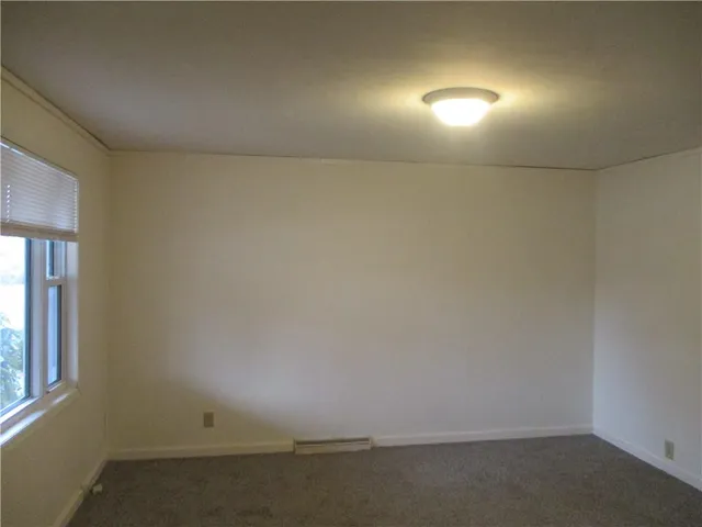 an empty room with a empty space and window