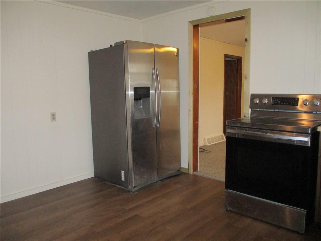 132 Armour Street Richeyville, PA 15358 - Photo 16 of 29 an empty room with wooden floor and a fireplace