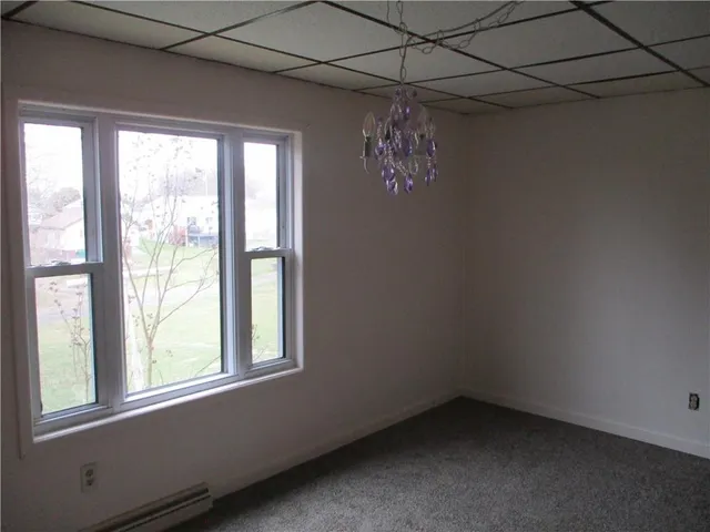 a view of a room that has a window and a chandelier
