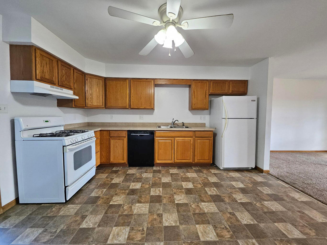 647 North Calumet Road Chesterton, IN 46304 - Photo 11 of 42 a kitchen with a stove a sink cabinets and a refrigerator