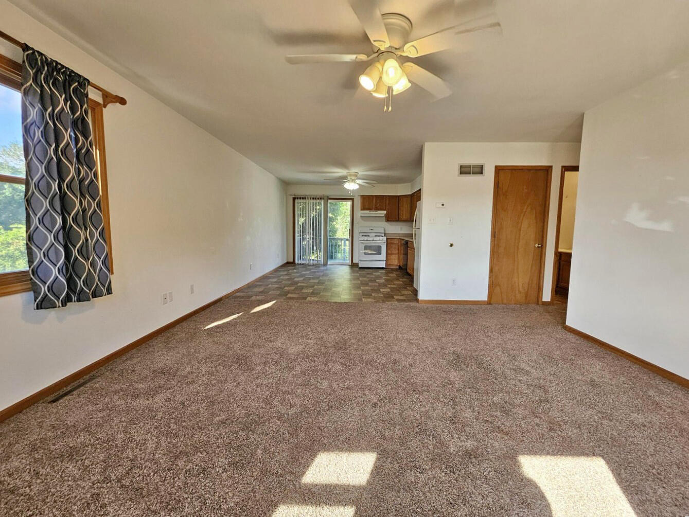 647 North Calumet Road Chesterton, IN 46304 - Photo 13 of 42 an empty room with a ceiling fan and a window