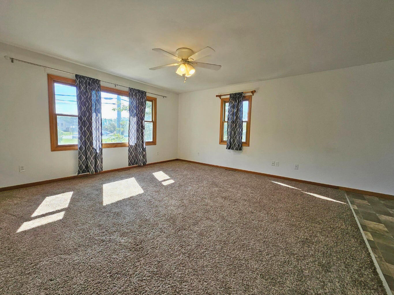 647 North Calumet Road Chesterton, IN 46304 - Photo 15 of 42 an empty room with windows and ceiling fan