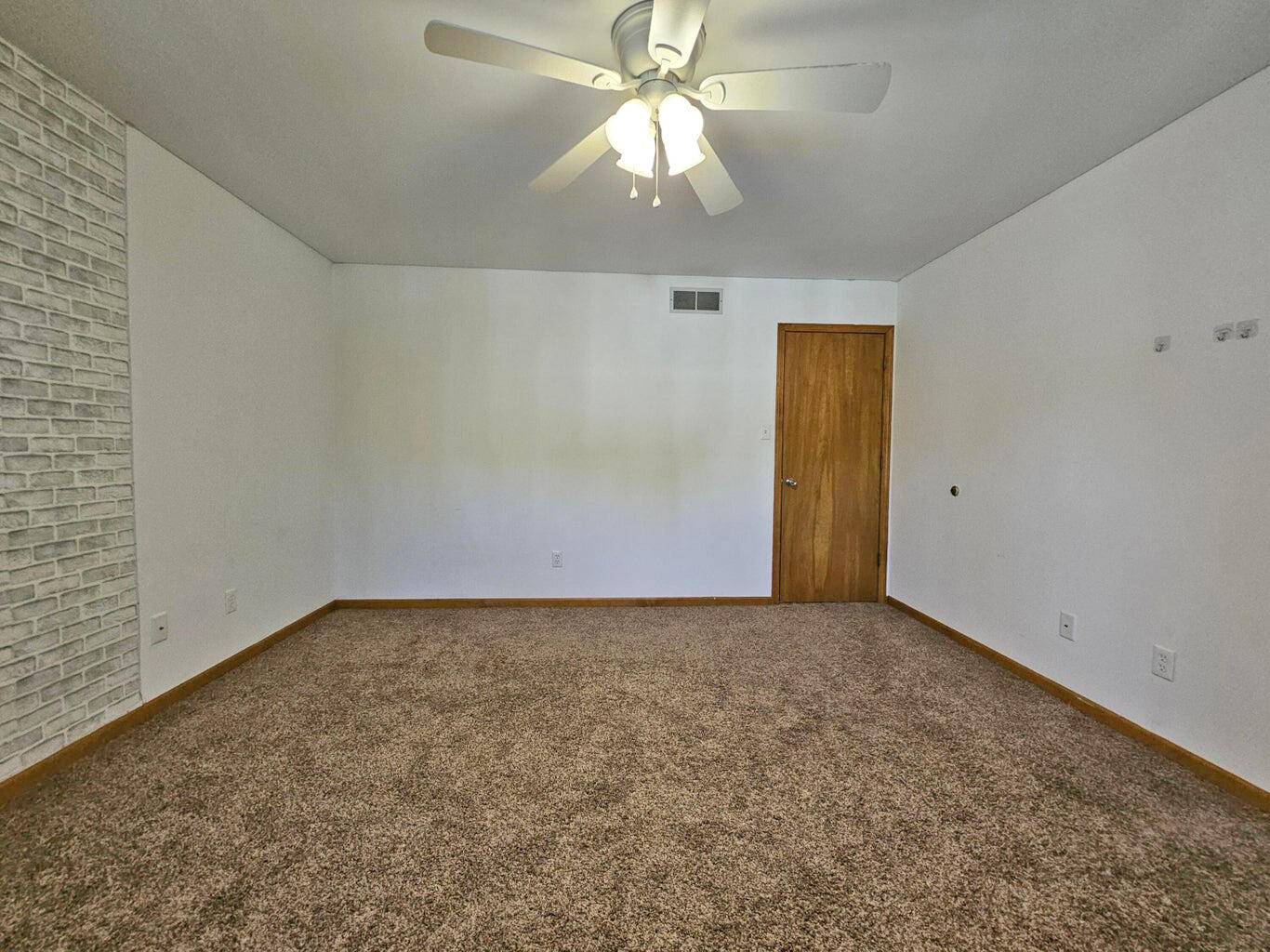 647 North Calumet Road Chesterton, IN 46304 - Photo 23 of 42 an empty room with a chandelier fan and windows
