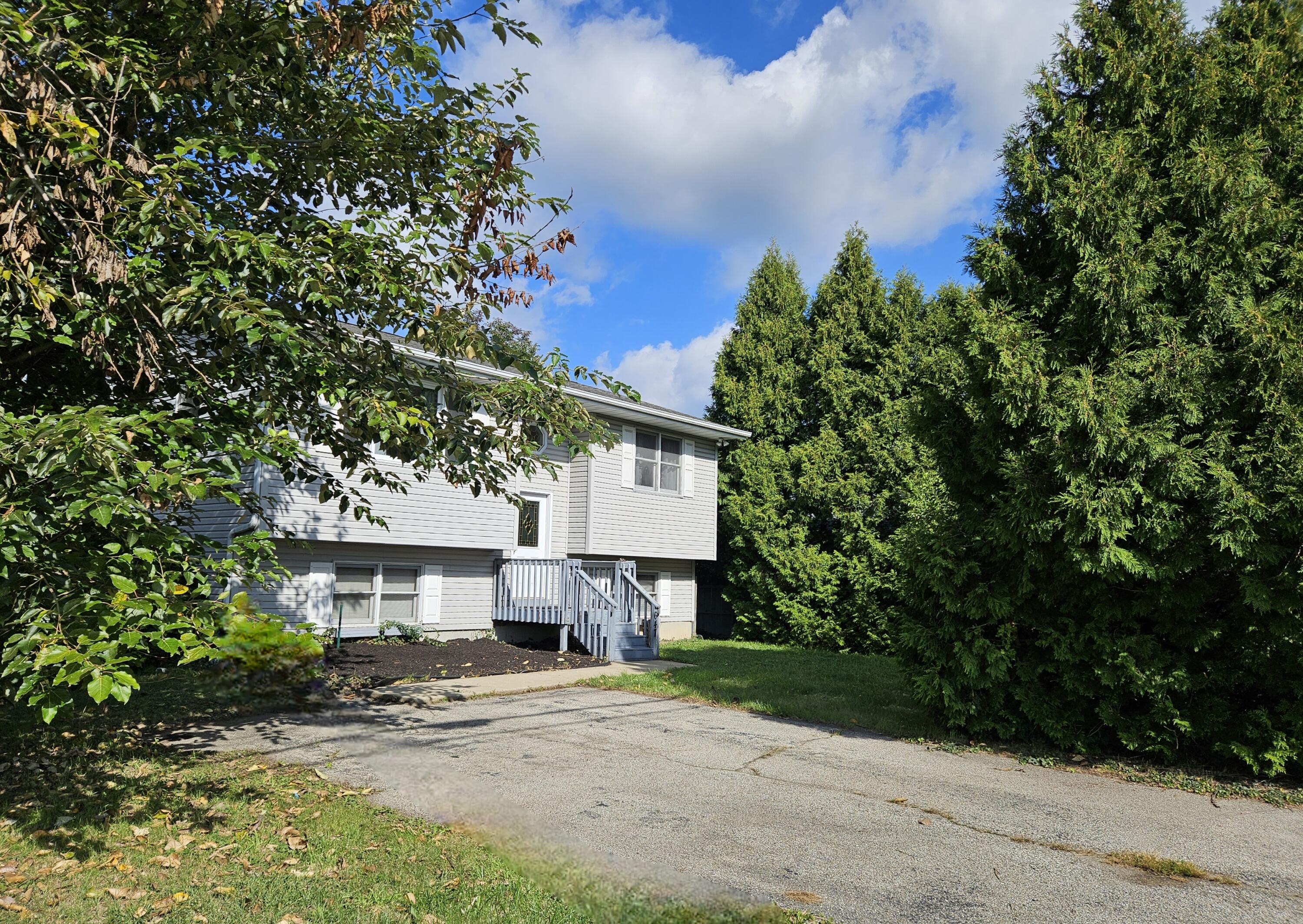 647 North Calumet Road Chesterton, IN 46304 - Photo 3 of 42 a front view of a house with a yard and tree