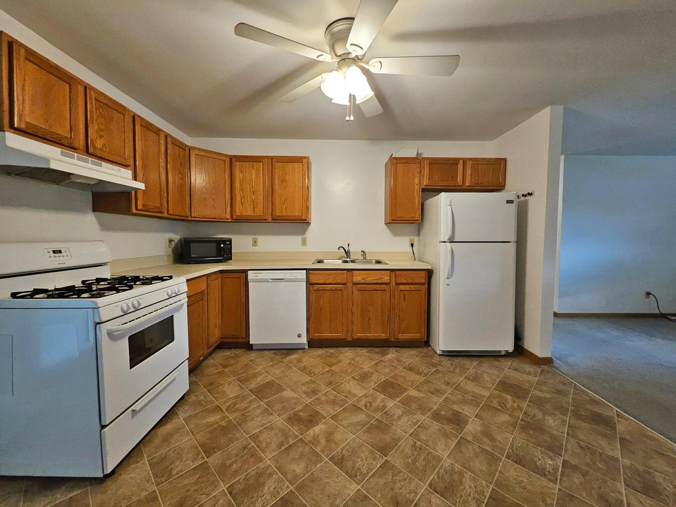 647 North Calumet Road Chesterton, IN 46304 - Photo 33 of 42 a kitchen with a stove a refrigerator and a sink