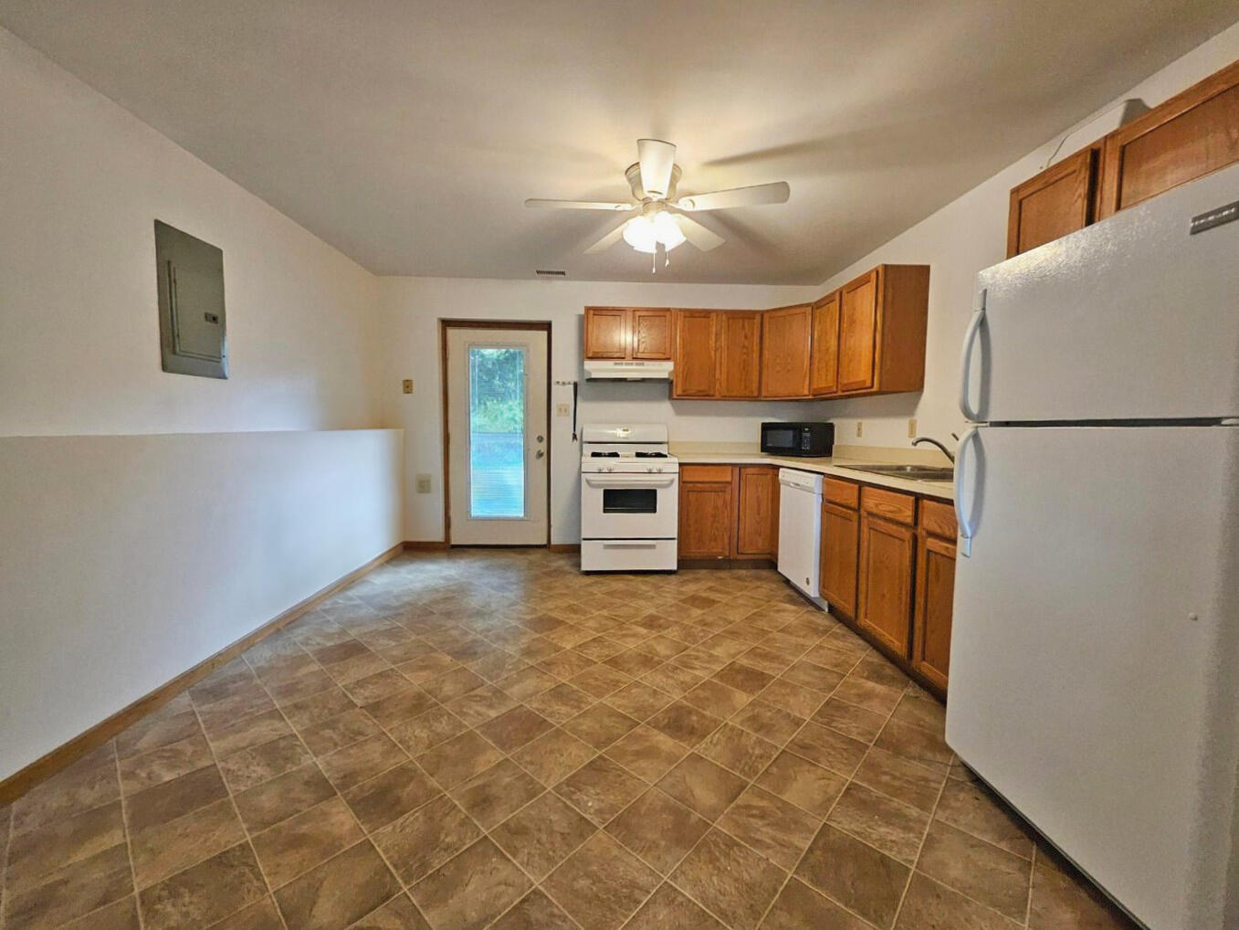 647 North Calumet Road Chesterton, IN 46304 - Photo 35 of 42 a kitchen with granite countertop a refrigerator stove top oven and sink