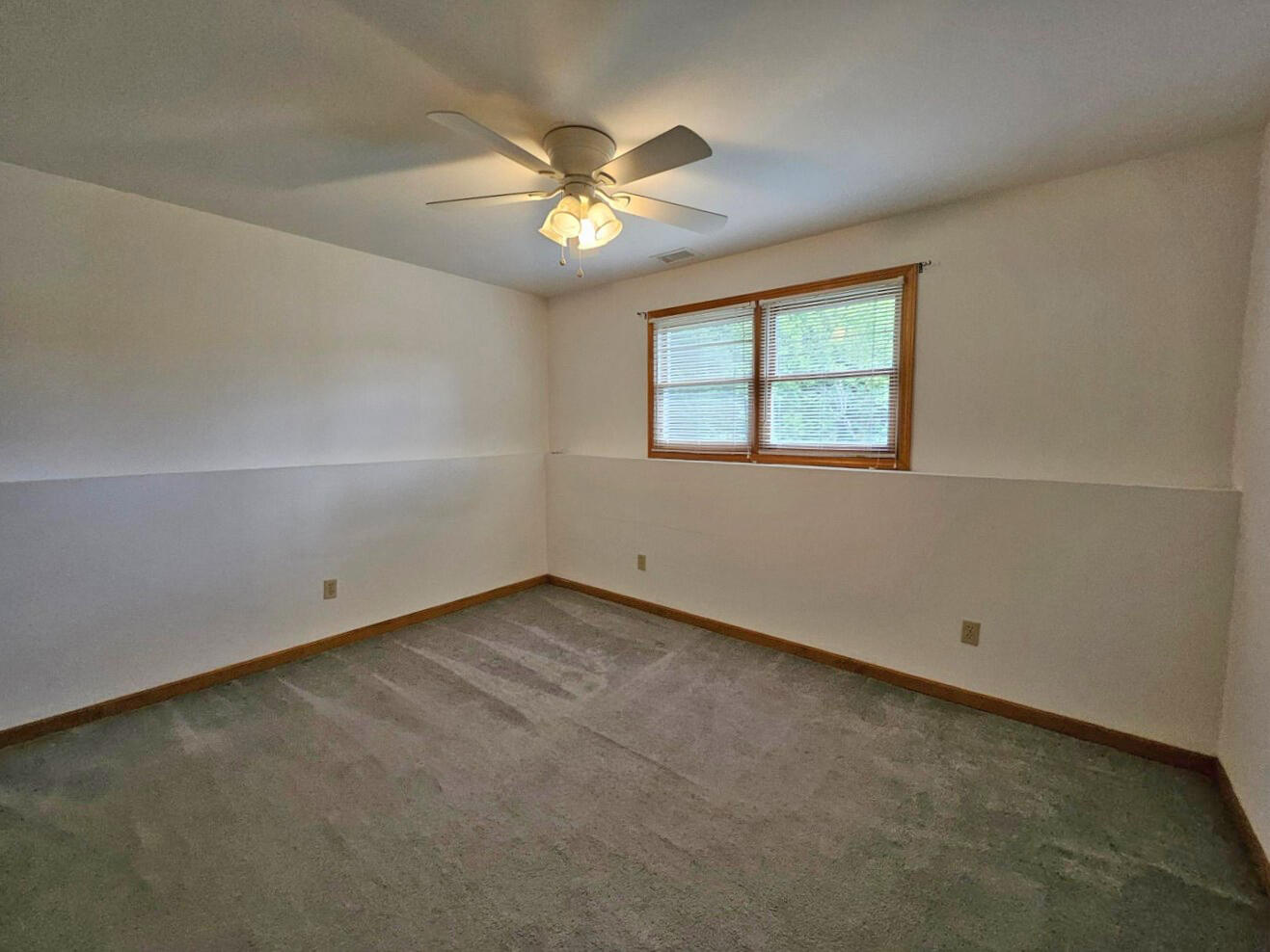 647 North Calumet Road Chesterton, IN 46304 - Photo 37 of 42 an empty room with a chandelier fan and windows