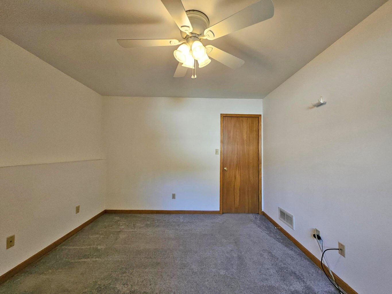 647 North Calumet Road Chesterton, IN 46304 - Photo 38 of 42 an empty room with a chandelier fan and windows