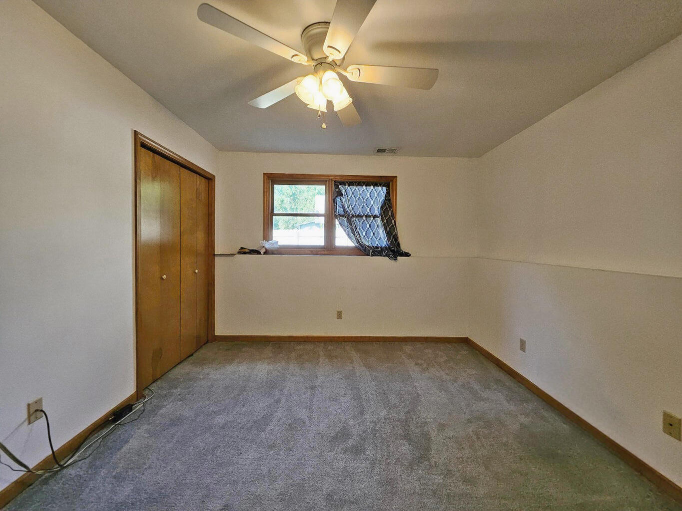 647 North Calumet Road Chesterton, IN 46304 - Photo 40 of 42 an empty room with a chandelier fan and windows