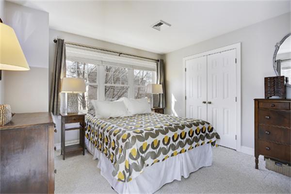 11 Whitney Street, Unit 11 Brookline, MA 02467 - Photo 12 of 20 a bedroom with a bed and a table in it with window