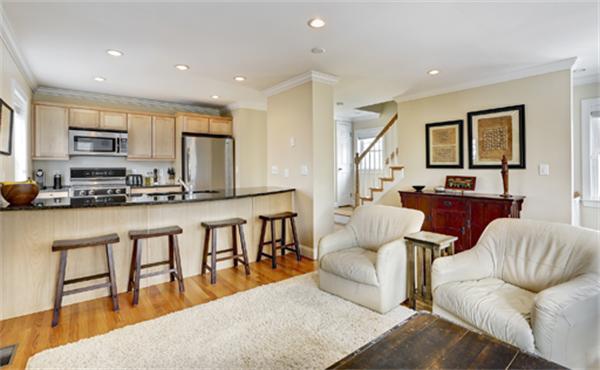 11 Whitney Street, Unit 11 Brookline, MA 02467 - Photo 4 of 20 a living room with stainless steel appliances kitchen island granite countertop a couch a dining table and chairs