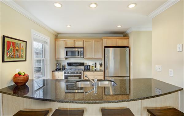 11 Whitney Street, Unit 11 Brookline, MA 02467 - Photo 7 of 20 a kitchen with stainless steel appliances granite countertop a sink refrigerator and cabinets