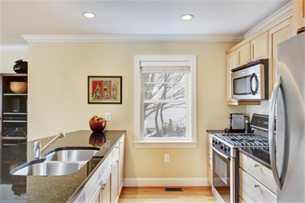 11 Whitney Street, Unit 11 Brookline, MA 02467 - Photo 8 of 20 a kitchen with stainless steel appliances granite countertop a sink stove and refrigerator