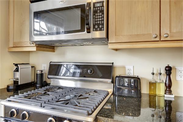 11 Whitney Street, Unit 11 Brookline, MA 02467 - Photo 9 of 20 a kitchen with a stove and a microwave