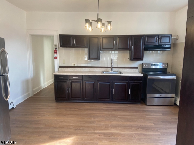 126 Main Street, Unit E Franklin, NJ 07416 - Photo 2 of 7 a kitchen with stainless steel appliances granite countertop a sink and a stove