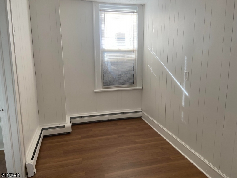 126 Main Street, Unit E Franklin, NJ 07416 - Photo 6 of 7 a view of an empty room with wooden floor and a window