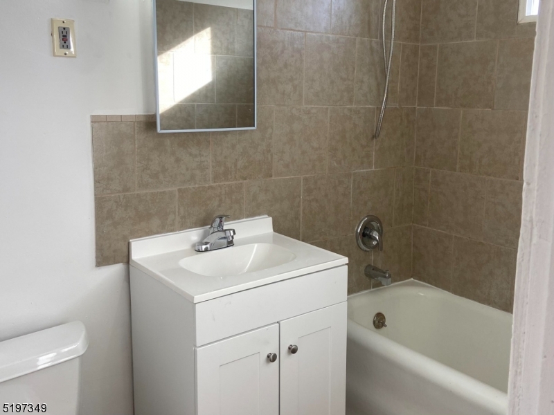 126 Main Street, Unit E Franklin, NJ 07416 - Photo 7 of 7 a bathroom with a sink a toilet and bathtub
