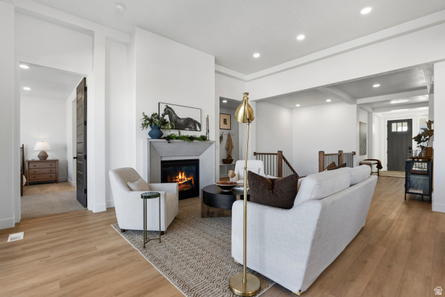 624 North Legend Circle, Unit 480 Mapleton, UT 84664 - Photo 11 of 34 Living room featuring wood finished floors, a glass covered fireplace, and recessed lighting