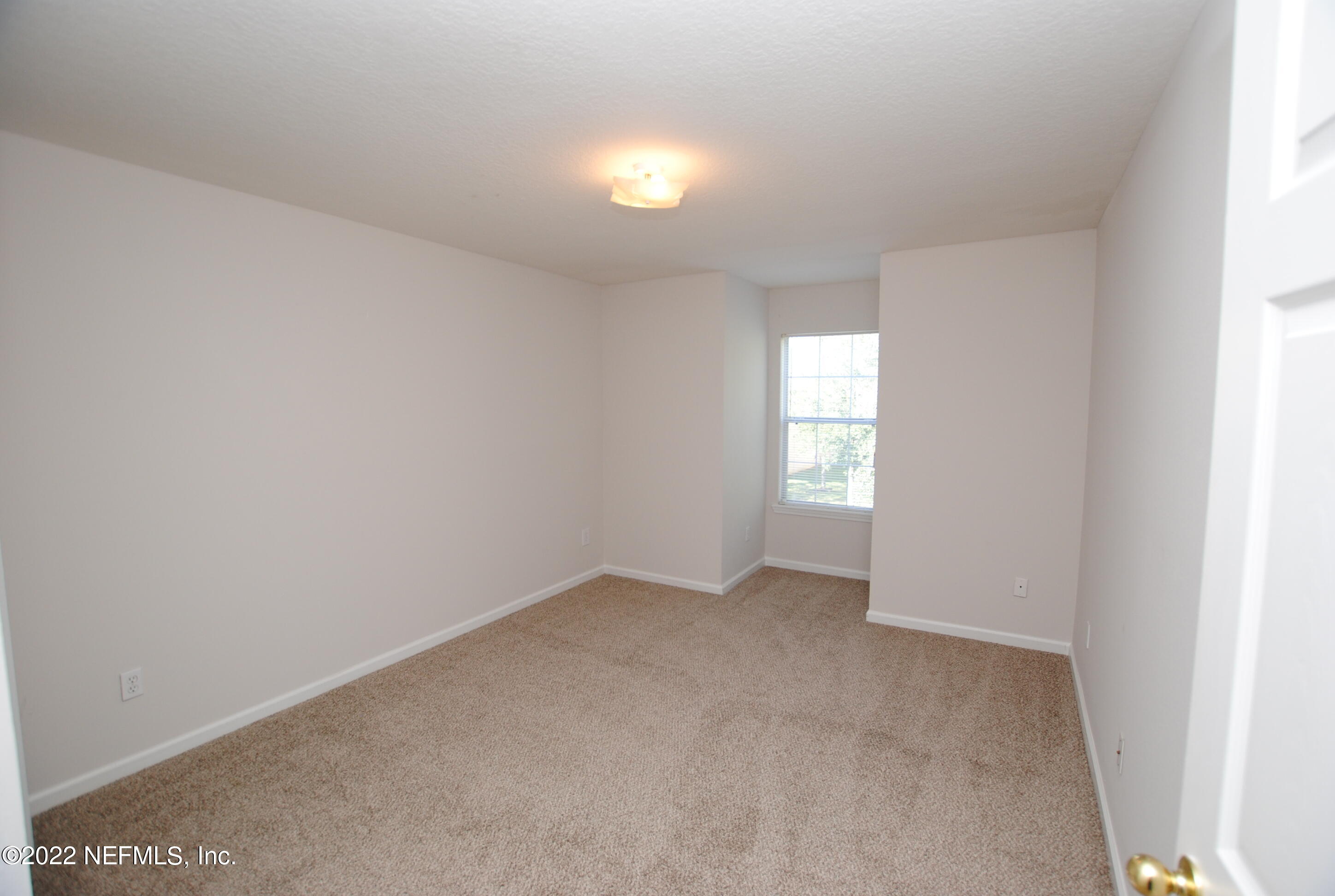 5260 Collins Road, Unit 505 Jacksonville, FL 32244 - Photo 16 of 20 a view of an empty room and window