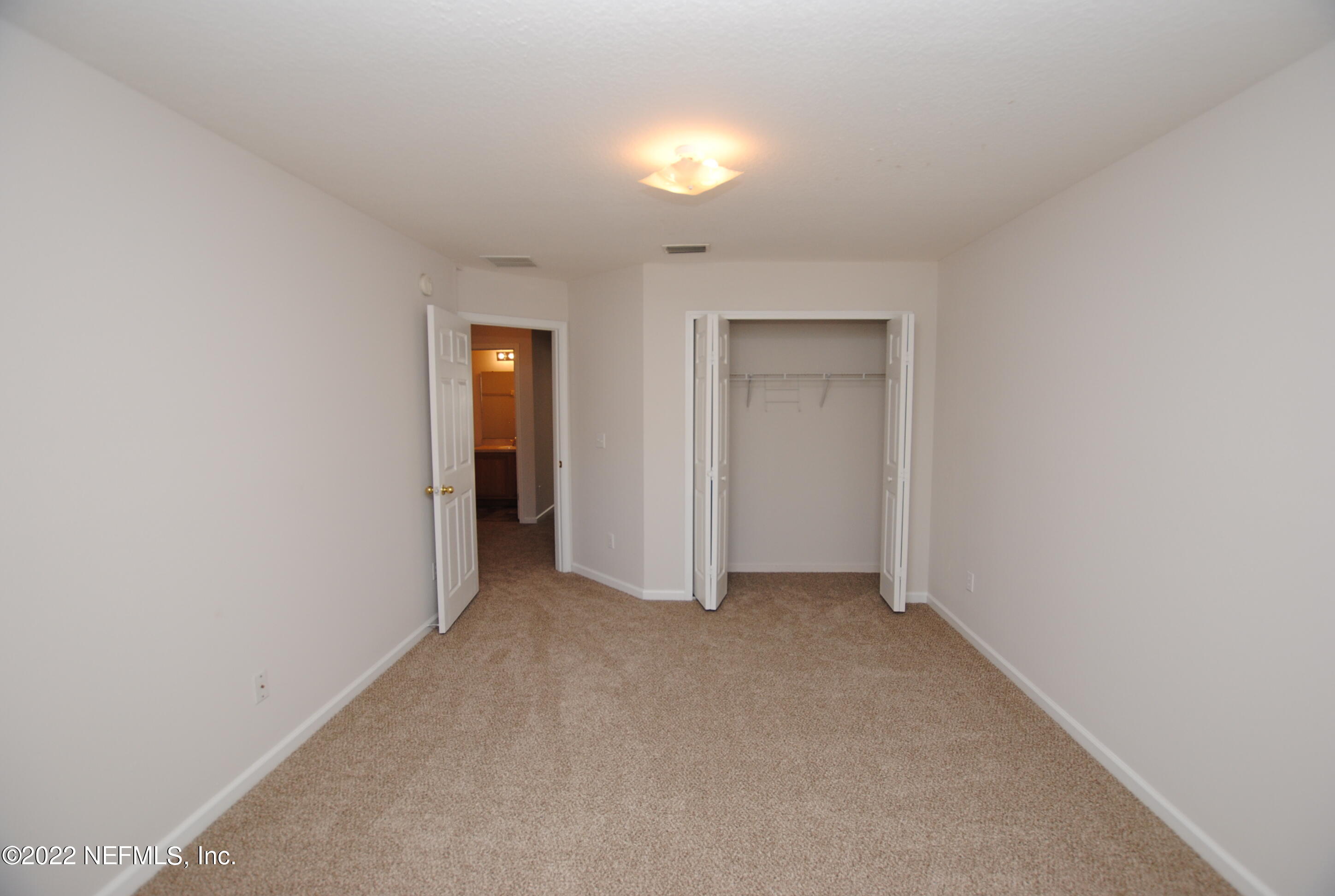 5260 Collins Road, Unit 505 Jacksonville, FL 32244 - Photo 17 of 20 a view of an empty room with closet and a window
