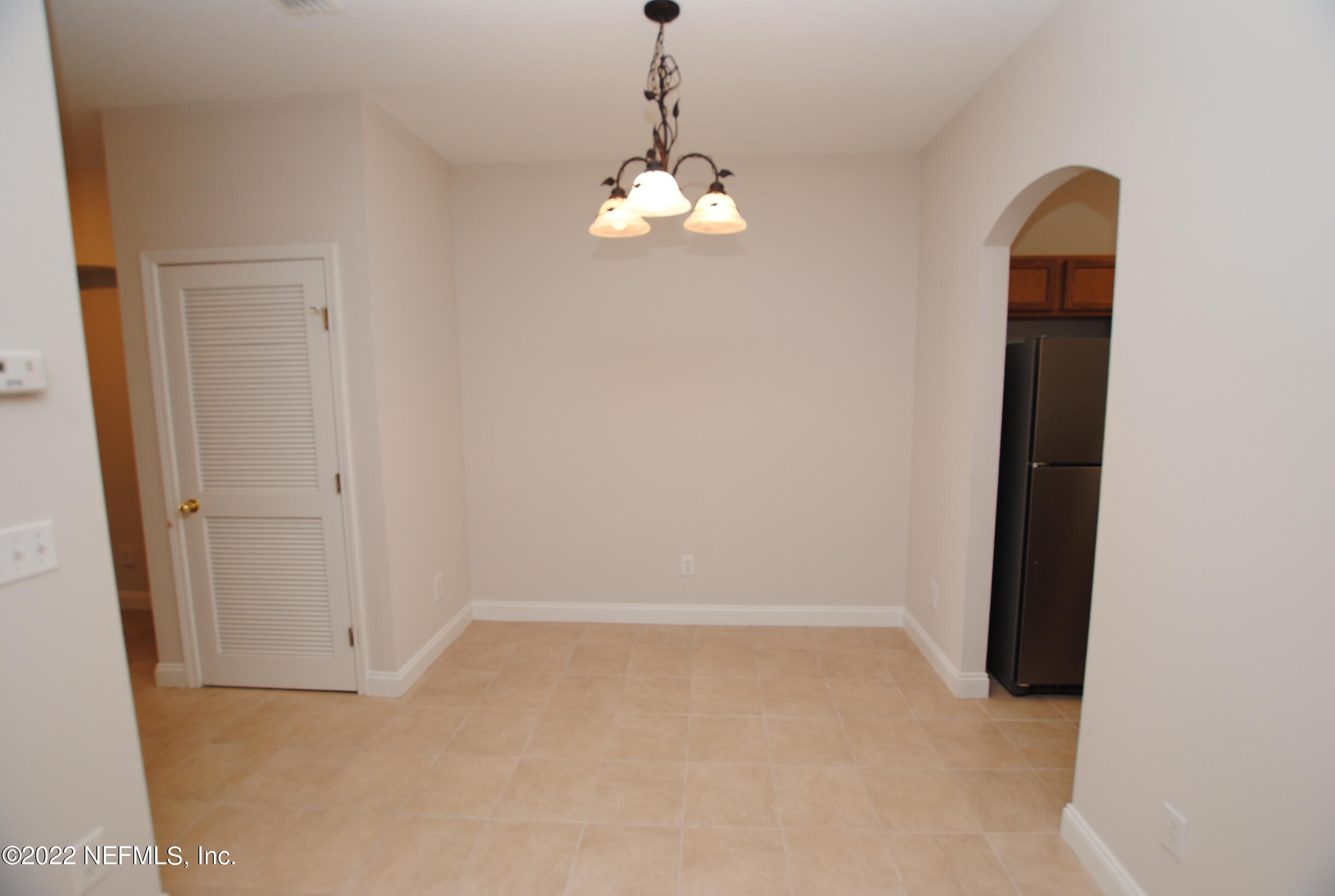 5260 Collins Road, Unit 505 Jacksonville, FL 32244 - Photo 9 of 20 an empty room with chandelier fan