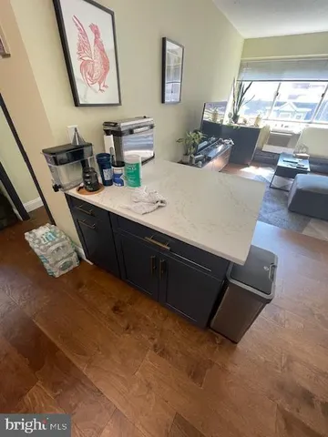 a kitchen with stainless steel appliances kitchen island granite countertop a refrigerator and a stove top oven