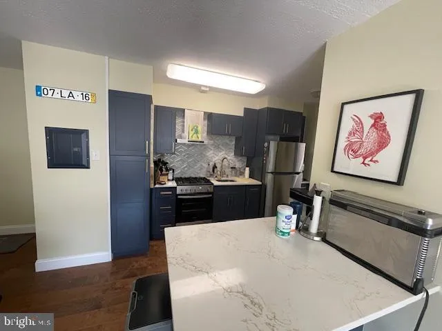 a kitchen with refrigerator and stove